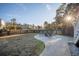 Landscaped backyard with paved patio, outdoor seating, and serene water views at 1464 Stratton Pl, Mount Pleasant, SC 29466