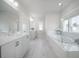 Spacious bathroom with double vanity, soaking tub and large window allowing ample natural light at 1464 Stratton Pl, Mount Pleasant, SC 29466
