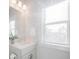 Sunlit bathroom features a vanity, window, and a serene ambiance for a relaxing experience at 1464 Stratton Pl, Mount Pleasant, SC 29466