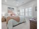 Inviting bedroom with warm colors, plantation shutters, and comfortable furnishings at 1464 Stratton Pl, Mount Pleasant, SC 29466