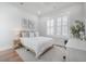 Light-filled bedroom with hardwood floors, shutters, a desk, and a plush bed for relaxation at 1464 Stratton Pl, Mount Pleasant, SC 29466