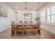 Dining room showcases an extended wooden table, stylish chandelier, and a decorative wall mirror at 1464 Stratton Pl, Mount Pleasant, SC 29466