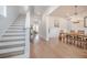 Bright entryway featuring hardwood floors, a staircase, and an adjacent dining area with stylish lighting at 1464 Stratton Pl, Mount Pleasant, SC 29466