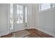 Bright entryway features wood floors and a glass door, welcoming natural light and outdoor views at 1464 Stratton Pl, Mount Pleasant, SC 29466