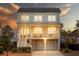 Charming two-story home with a welcoming front porch and a two-car garage under the main structure at 1464 Stratton Pl, Mount Pleasant, SC 29466