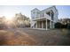 A beautiful two-story home features a spacious yard, deck, and elevated construction at 1464 Stratton Pl, Mount Pleasant, SC 29466