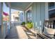 Inviting front porch adorned with plants and a rocking chair, perfect for relaxing and enjoying the peaceful surroundings at 1464 Stratton Pl, Mount Pleasant, SC 29466