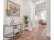 Hallway features wood floors, plant decor and an elegant display table with artwork at 1464 Stratton Pl, Mount Pleasant, SC 29466