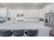 Spacious kitchen featuring white cabinets, stainless steel appliances, and island with seating at 1464 Stratton Pl, Mount Pleasant, SC 29466