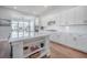Contemporary kitchen with white cabinets, hardwood floors, and a breakfast area at 1464 Stratton Pl, Mount Pleasant, SC 29466