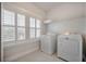 Bright laundry room featuring white appliances, a window, and a wire shelf for storage at 1464 Stratton Pl, Mount Pleasant, SC 29466