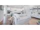 Open-concept living room flows into a modern kitchen with sleek white cabinetry at 1464 Stratton Pl, Mount Pleasant, SC 29466