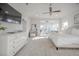 Bright main bedroom featuring hardwood floors and ceiling fan with sitting area overlooking the yard at 1464 Stratton Pl, Mount Pleasant, SC 29466