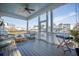 Inviting screened porch with ceiling fan, string lights, and waterfront views at 1464 Stratton Pl, Mount Pleasant, SC 29466
