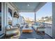 Comfortable screened porch with plush seating, outdoor TV, and scenic water views at 1464 Stratton Pl, Mount Pleasant, SC 29466