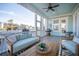 Charming screened porch with comfortable seating and serene waterfront vistas at 1464 Stratton Pl, Mount Pleasant, SC 29466