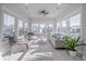 Bright sitting room featuring windows, ceiling fan and stylish modern furniture at 1464 Stratton Pl, Mount Pleasant, SC 29466
