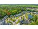 An aerial view of a community with homes, winding streets with mature trees, and a serene lake at 1510 Windlass Way, Mount Pleasant, SC 29466