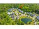An aerial view of a community with homes, a small lake, and winding streets with mature trees at 1510 Windlass Way, Mount Pleasant, SC 29466