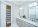 Bathroom with double vanity, marble countertops, modern fixtures, and walk-in closet at 1510 Windlass Way, Mount Pleasant, SC 29466