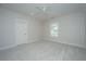 Cozy bedroom with neutral carpet, a ceiling fan, a window, and a door at 1510 Windlass Way, Mount Pleasant, SC 29466