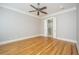 Spacious bedroom with hardwood floors, crown molding, ceiling fan and a door to the ensuite bath at 1510 Windlass Way, Mount Pleasant, SC 29466