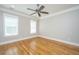 Comfortable bedroom with hardwood floors, and natural light from the two windows at 1510 Windlass Way, Mount Pleasant, SC 29466