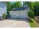 Detached two-car garage with white doors, matching trim, and ample parking space at 1510 Windlass Way, Mount Pleasant, SC 29466