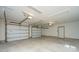 Spacious garage with two white overhead doors, concrete flooring, and ample ceiling lighting at 1510 Windlass Way, Mount Pleasant, SC 29466