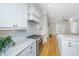 Stylish kitchen with stainless steel range, white cabinets, and a marble countertop for cooking and entertaining at 1510 Windlass Way, Mount Pleasant, SC 29466