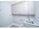 Bright laundry room with gray cabinets, tile floors, and a stainless steel sink at 1510 Windlass Way, Mount Pleasant, SC 29466