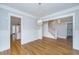 Open-concept living room with hardwood floors, leading to a staircase and a modern kitchen area at 1510 Windlass Way, Mount Pleasant, SC 29466