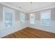 Bright living room with hardwood floors, wainscoting, and large windows creating a warm and inviting space at 1510 Windlass Way, Mount Pleasant, SC 29466