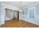 Bright living room with hardwood floors, wainscoting, large windows and stylish lighting fixture at 1510 Windlass Way, Mount Pleasant, SC 29466