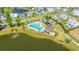 Aerial view of a community pool with lounge chairs, tables, cabanas, a lake, and manicured landscaping at 1510 Windlass Way, Mount Pleasant, SC 29466