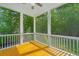 Relaxing screened porch with wood floors, open views, and ceiling fan at 1510 Windlass Way, Mount Pleasant, SC 29466