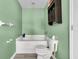 Cozy bathroom featuring a built-in tub, toilet, and dark wooden wall storage at 1516 Mandarin Ct, Summerville, SC 29483