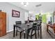 Open concept dining room showcases a dark wood table, with seating for six, seamlessly connected to other living spaces at 1516 Mandarin Ct, Summerville, SC 29483