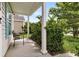 Inviting front porch with ample space for seating, charming curb appeal and a lushly landscaped garden at 1516 Mandarin Ct, Summerville, SC 29483