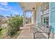 Charming front porch with a bench, decorative pillow, ample space, complemented by blue shutters and well-maintained landscaping at 1516 Mandarin Ct, Summerville, SC 29483