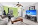 Bright living room with a comfortable sofa, coffee table, an entertainment center with a large television, and a window view at 1516 Mandarin Ct, Summerville, SC 29483