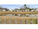 Backyard pond view behind homes featuring a decorative wooden fence on a sunny day at 1516 Mandarin Ct, Summerville, SC 29483