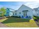 Neat backyard featuring a lush green lawn, patio furniture, and charming landscaping at 1521 Pogonia St # 4, Mount Pleasant, SC 29466
