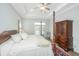 Primary bedroom features a four-poster bed, a ceiling fan, and ample natural light at 1521 Pogonia St # 4, Mount Pleasant, SC 29466