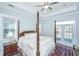 Spacious bedroom with a four-poster bed, tray ceiling, and access to a balcony at 1521 Pogonia St # 4, Mount Pleasant, SC 29466