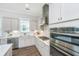 Well-lit kitchen with stainless steel appliances, white cabinets, and modern fixtures at 1521 Pogonia St # 4, Mount Pleasant, SC 29466