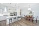 Open kitchen and dining area with stainless appliances, island seating, and hardwood floors at 1521 Pogonia St # 4, Mount Pleasant, SC 29466