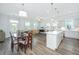 Open concept living room with hardwood floors, a dining area, and a modern kitchen at 1521 Pogonia St # 4, Mount Pleasant, SC 29466