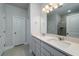 Bright bathroom featuring double sinks, white cabinetry, a large mirror, and ample counter space at 154 Royal Cainhoy Way, Huger, SC 29450