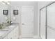 Clean bathroom featuring a glass-enclosed shower, granite countertops, and framed mirror at 154 Royal Cainhoy Way, Huger, SC 29450